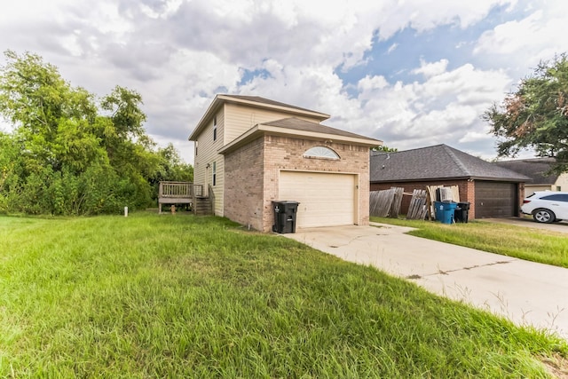 view of home's exterior with a lawn, a garage, and a deck