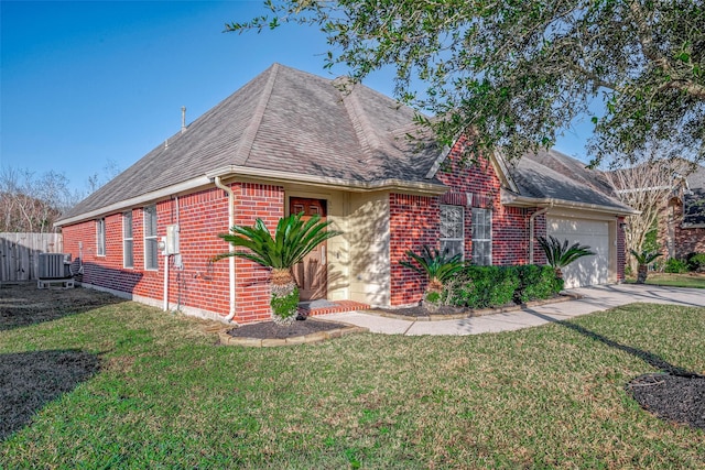 view of front facade featuring a front yard, a garage, and cooling unit