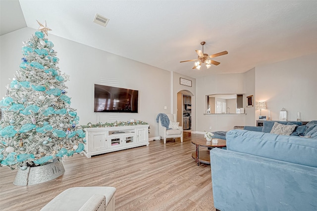 living room with light hardwood / wood-style floors and ceiling fan