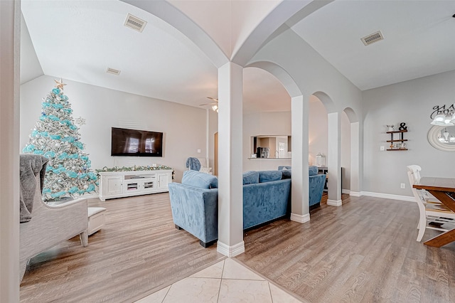 living room with ceiling fan and wood-type flooring