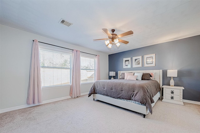 bedroom featuring ceiling fan and light carpet