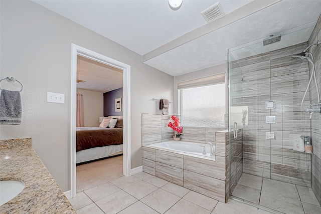 bathroom featuring tile patterned floors, vanity, and plus walk in shower