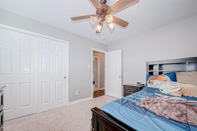 carpeted bedroom with a closet and ceiling fan