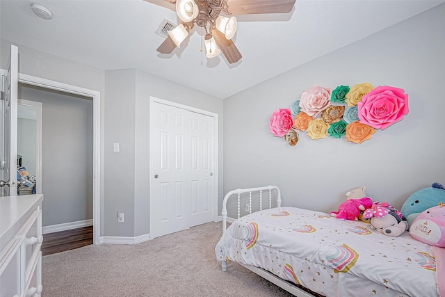 bedroom featuring ceiling fan, light carpet, and a closet