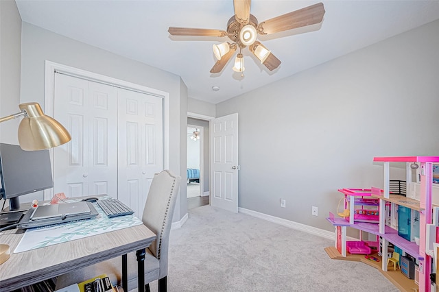 carpeted office space with ceiling fan