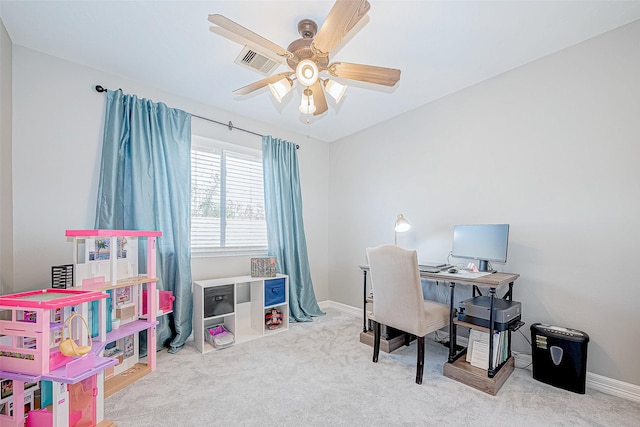 home office featuring light carpet and ceiling fan