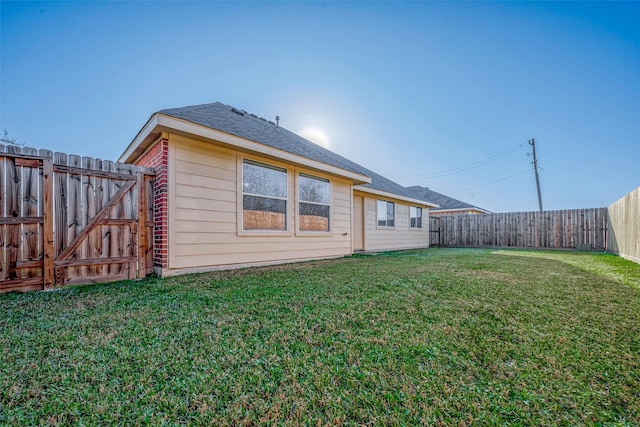 rear view of property with a lawn