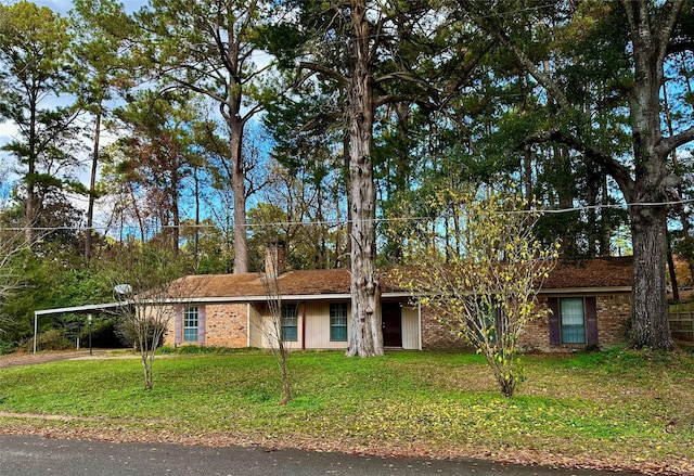 ranch-style home with a front lawn and a carport