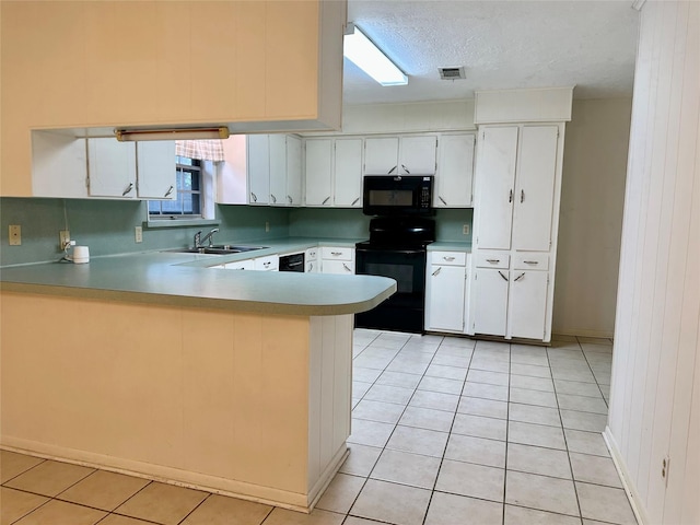 kitchen featuring black appliances, light tile patterned flooring, white cabinets, and kitchen peninsula