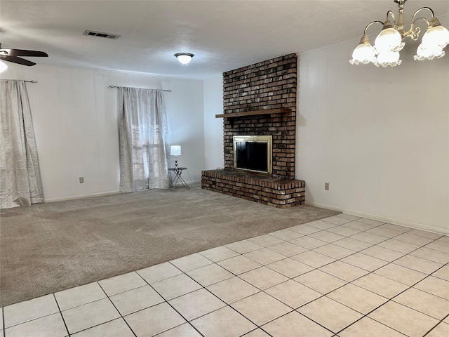 unfurnished living room featuring a textured ceiling, ceiling fan with notable chandelier, light colored carpet, and a fireplace