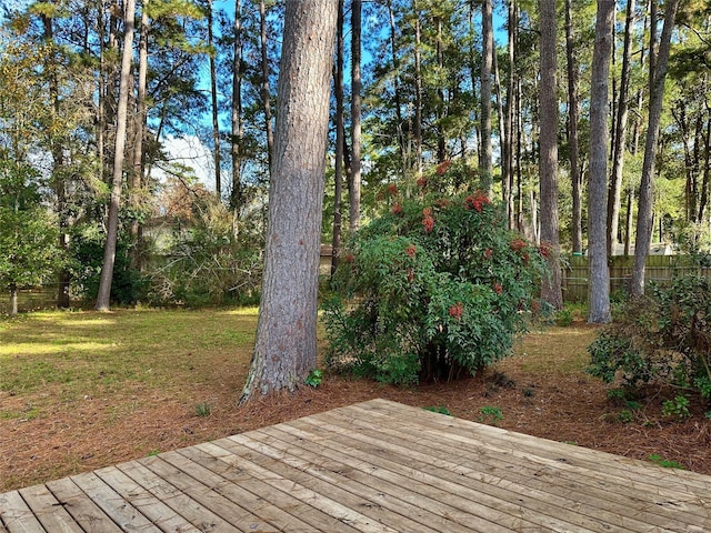 wooden deck featuring a yard