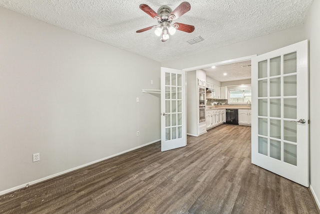 spare room with french doors, a textured ceiling, hardwood / wood-style flooring, and ceiling fan