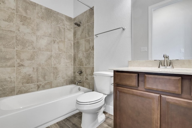 full bathroom featuring vanity, toilet, and tiled shower / bath