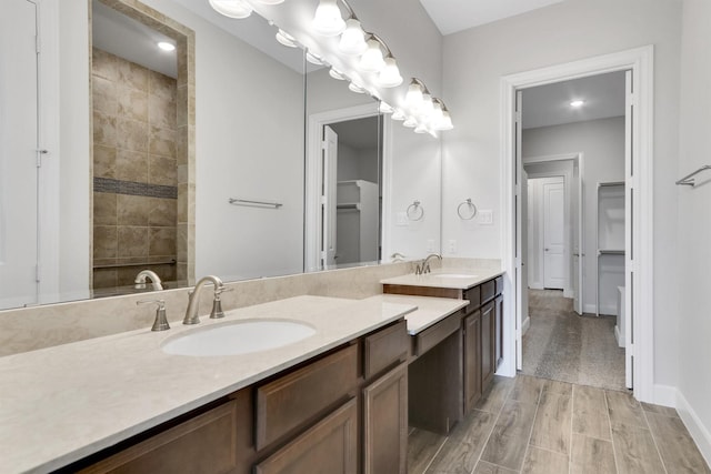 bathroom featuring a shower and vanity