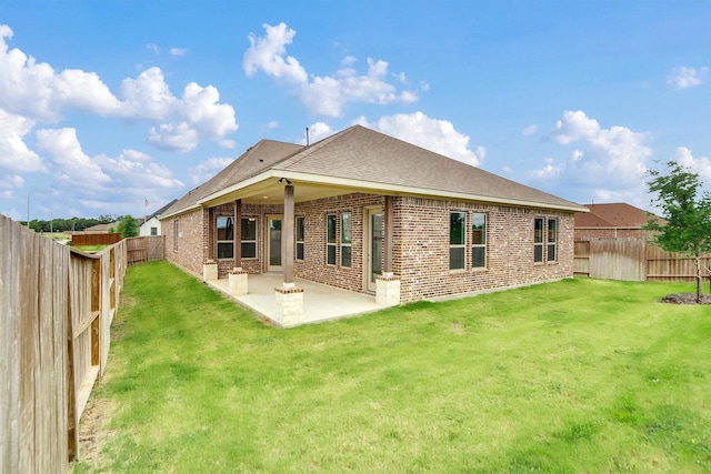 back of house featuring a yard and a patio