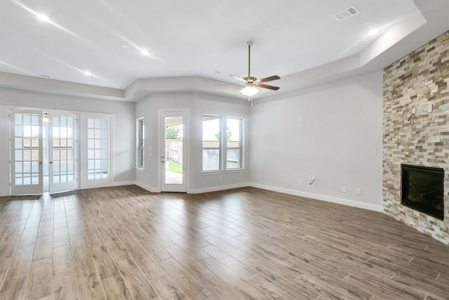 unfurnished living room featuring a fireplace and ceiling fan