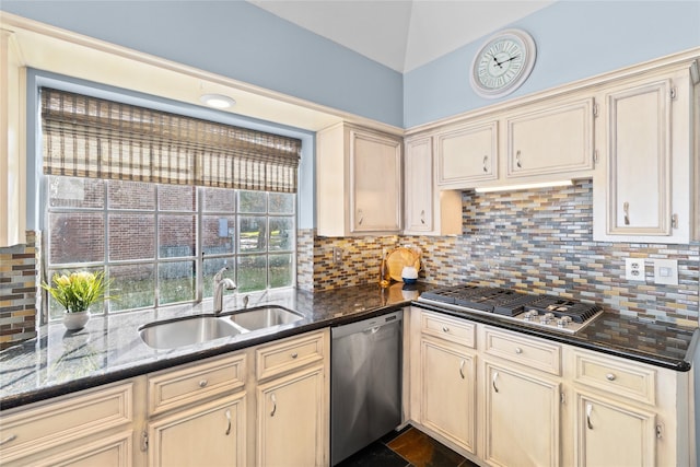 kitchen with tasteful backsplash, cream cabinets, sink, and stainless steel appliances