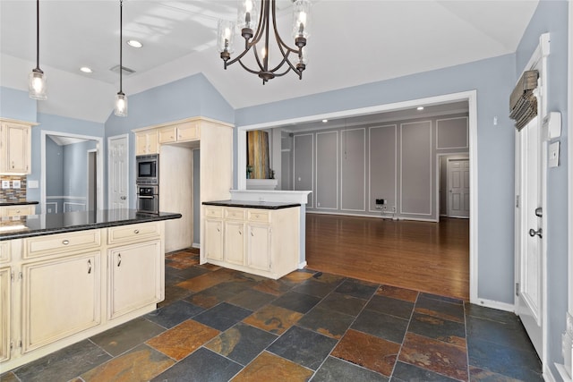 kitchen with dark hardwood / wood-style flooring, cream cabinets, oven, hanging light fixtures, and lofted ceiling