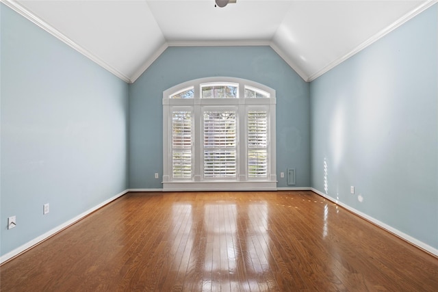 unfurnished room featuring hardwood / wood-style floors, vaulted ceiling, and ornamental molding