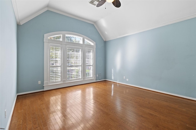 empty room featuring hardwood / wood-style flooring, vaulted ceiling, ceiling fan, and crown molding