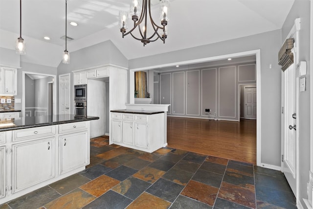 kitchen with stainless steel oven, pendant lighting, a notable chandelier, white cabinets, and lofted ceiling