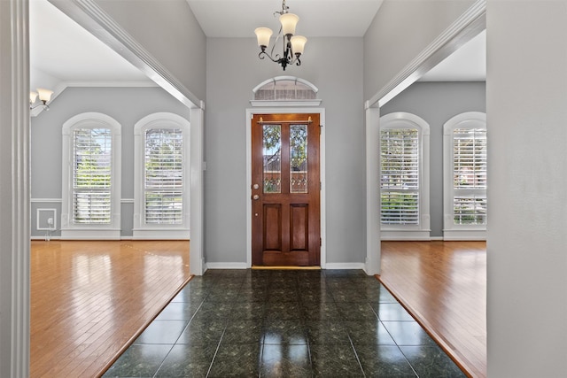 entryway with a chandelier and a towering ceiling