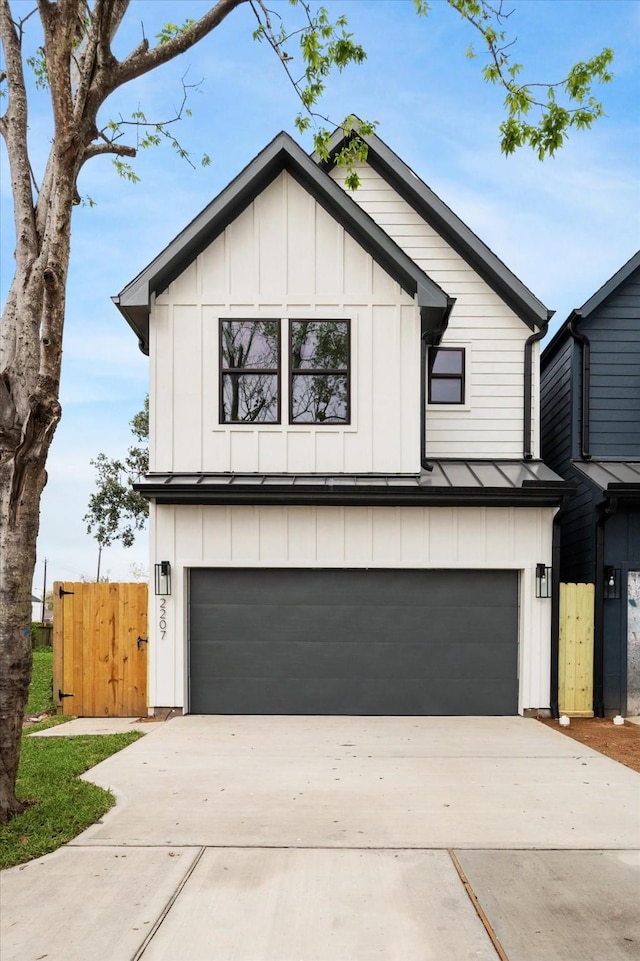 modern inspired farmhouse featuring a standing seam roof, driveway, and board and batten siding