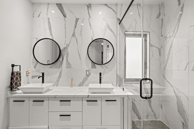 bathroom with vanity and a shower with shower door