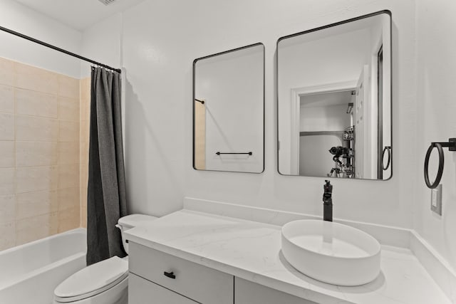 full bathroom with vanity, shower / tub combo, and toilet