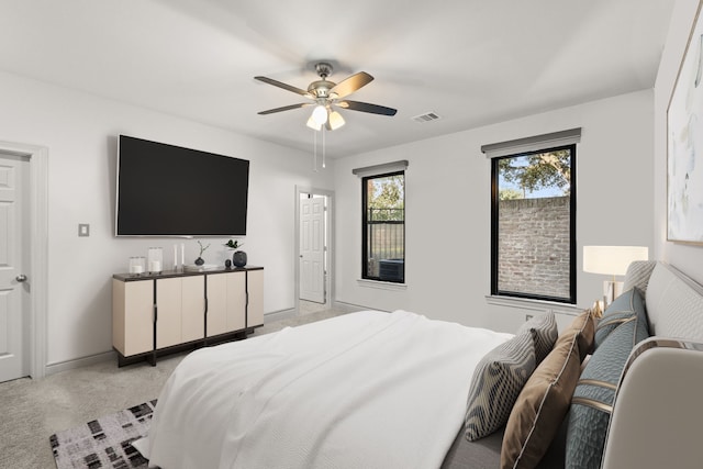 bedroom featuring light carpet and ceiling fan