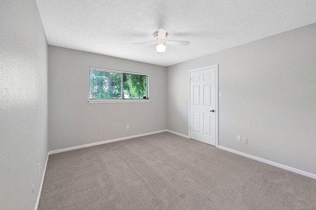 unfurnished room featuring light carpet, ceiling fan, and a textured ceiling