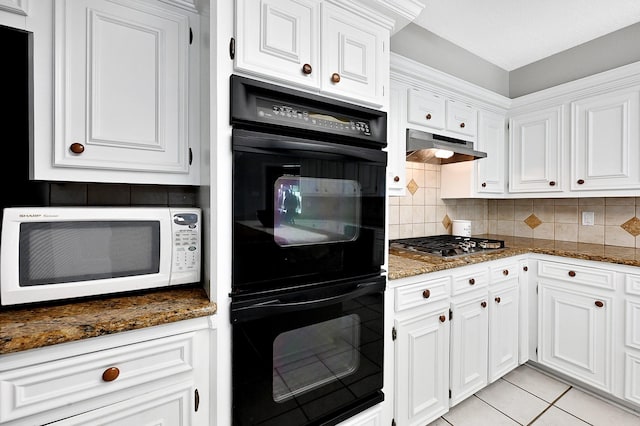 kitchen featuring white cabinets, decorative backsplash, black double oven, and stainless steel gas cooktop