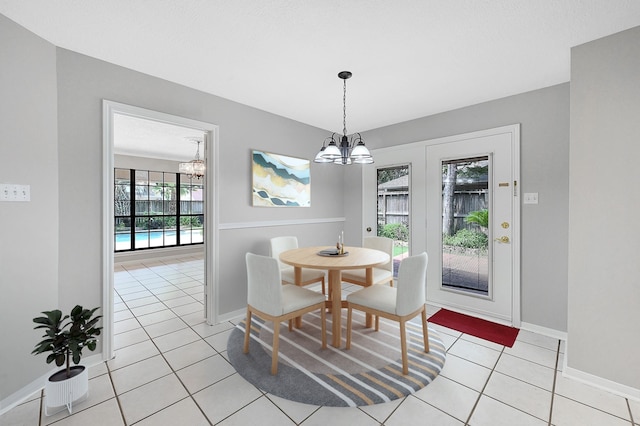 tiled dining space featuring a notable chandelier