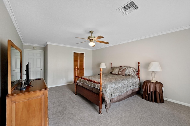 carpeted bedroom featuring a textured ceiling, ceiling fan, and ornamental molding