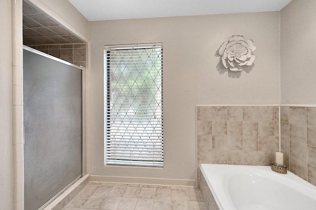 bathroom featuring independent shower and bath