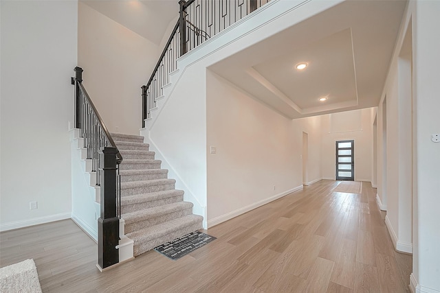 28212 Cedar Peak Dr, Spring, TX 77386 - entryway with light wood-style flooring, stairway, a tray ceiling, and recessed lighting