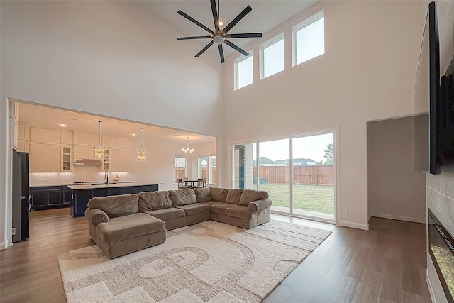 28212 Cedar Peak Dr, Spring, TX 77386 - living area featuring a high ceiling, wood finished floors, and ceiling fan