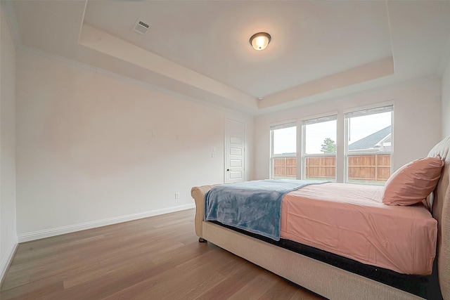 28212 Cedar Peak Dr, Spring, TX 77386 - bedroom featuring a raised ceiling and wood finished floors