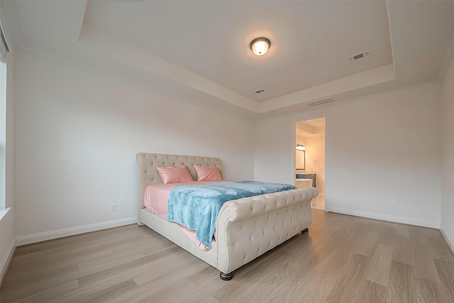 28212 Cedar Peak Dr, Spring, TX 77386 - bedroom featuring a tray ceiling, wood finished floors, and ensuite bath