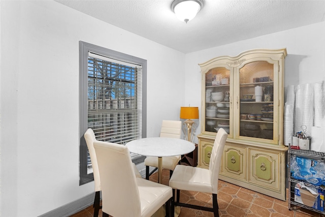 dining area featuring a textured ceiling