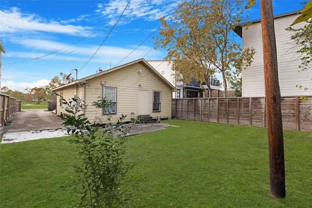 back of house with a yard and a patio area