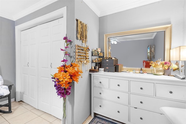 interior space with tile patterned flooring, vanity, ceiling fan, and crown molding