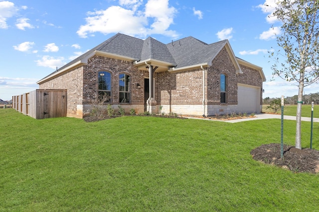 view of front of house with a front yard and a garage