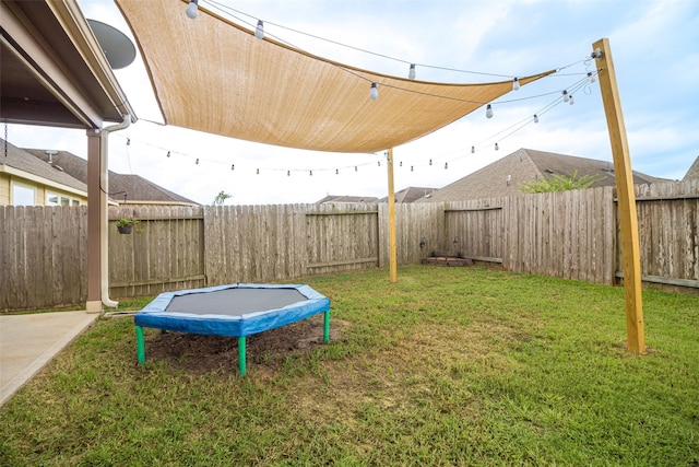 view of yard with a trampoline