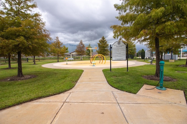 view of home's community featuring a playground and a yard