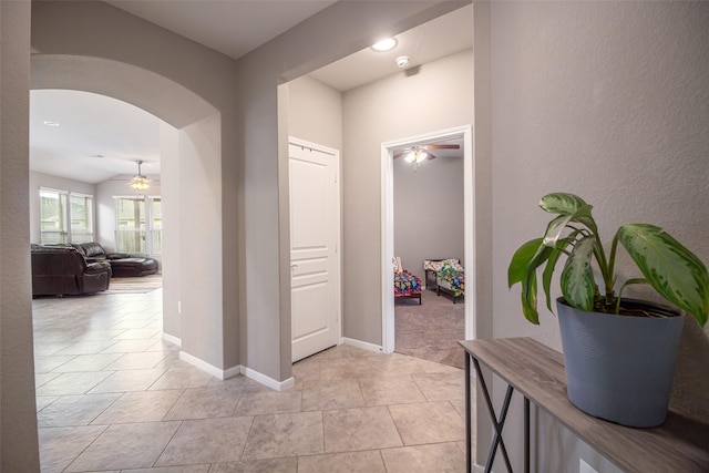 corridor with light carpet and lofted ceiling