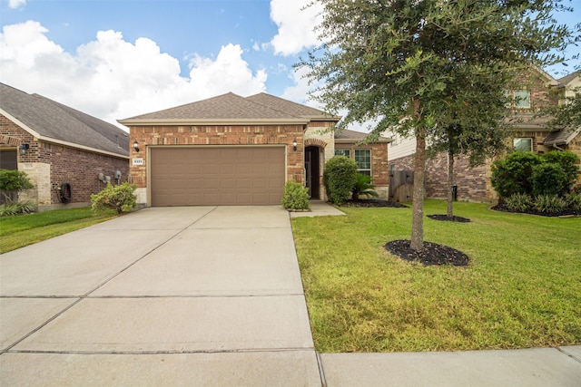 view of front of property with a front lawn and a garage