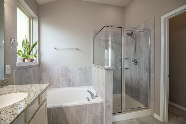 bathroom with vanity and separate shower and tub