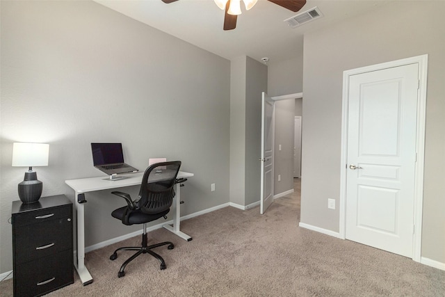 carpeted office space featuring ceiling fan