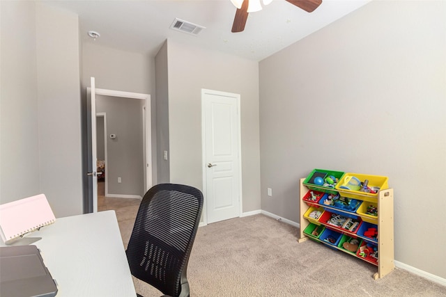 office space with light carpet and ceiling fan